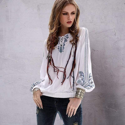 A lady wearing a Bohemian Lantern Sleeve Blouse in a blue jeans paired with accessories.