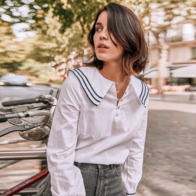 A lady wearing a Striped Sailor Blouse in a blue jeans.