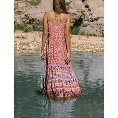 A lady wearing a Bohemian Noodle Strap Beach Dress paired with accessories back view.