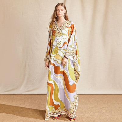 A lady wearing Batwing Maxi Chiffon Loungewear Dress front view paired with accessories and colorful sandals.