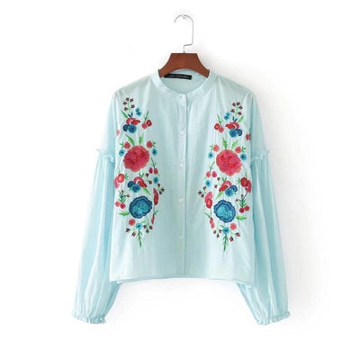 Vintage Lantern Sleeve Floral Embroidery Blouse front view in a wooden hanger.